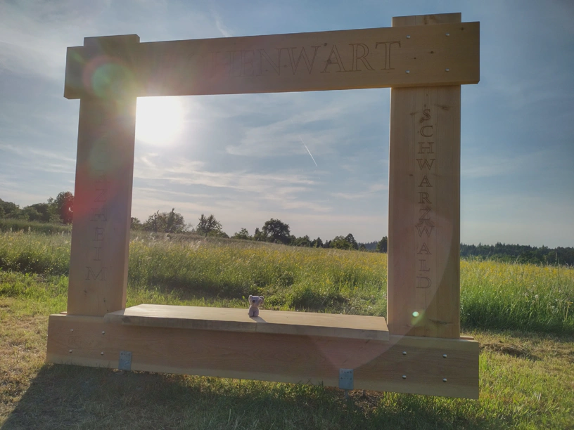Der kleine Elefant im Fotorahmen. Dazu im Hintergrund die Abendsonne und ein schöner Himmel.